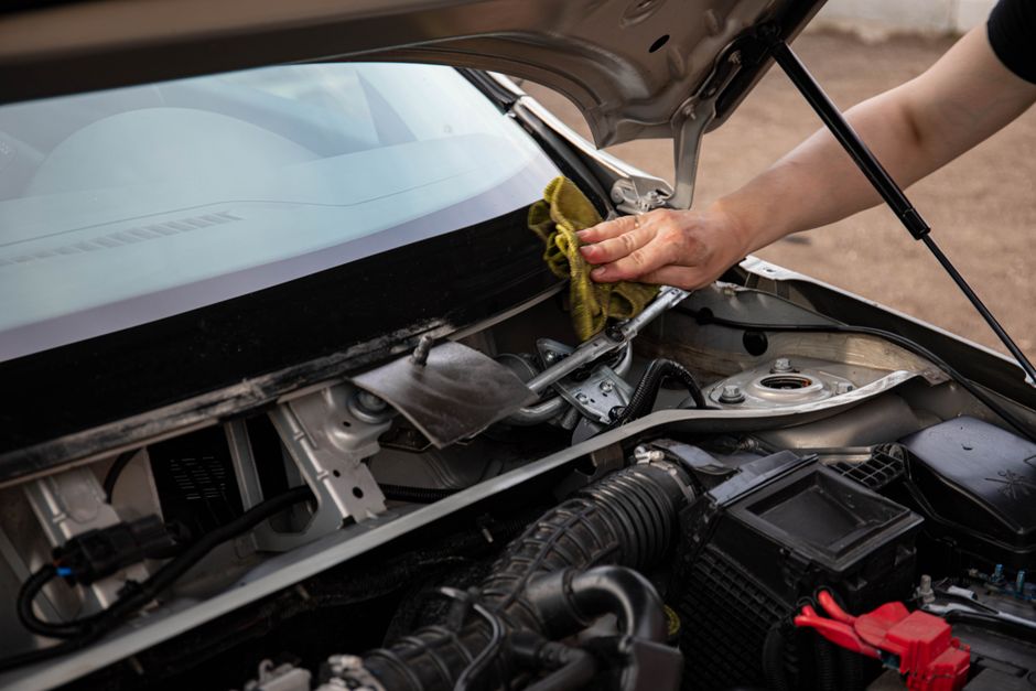 Technician precisely repairing a minor chip on auto glass